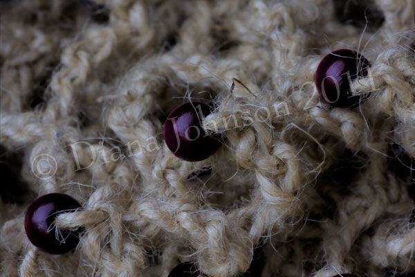 Purple wooden beads on string bag