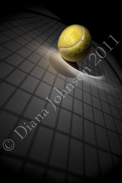 Tennis ball and racquet shadow
